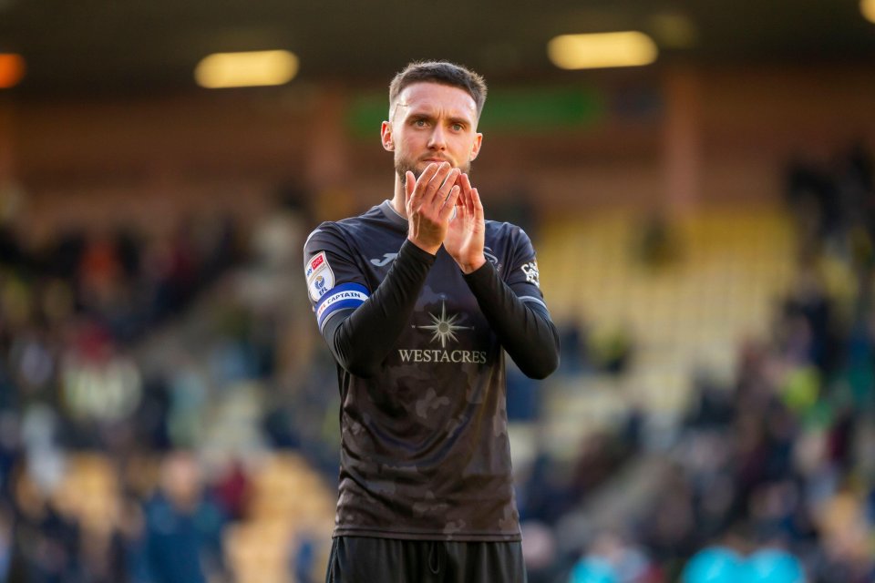 Swansea City player applauding fans.