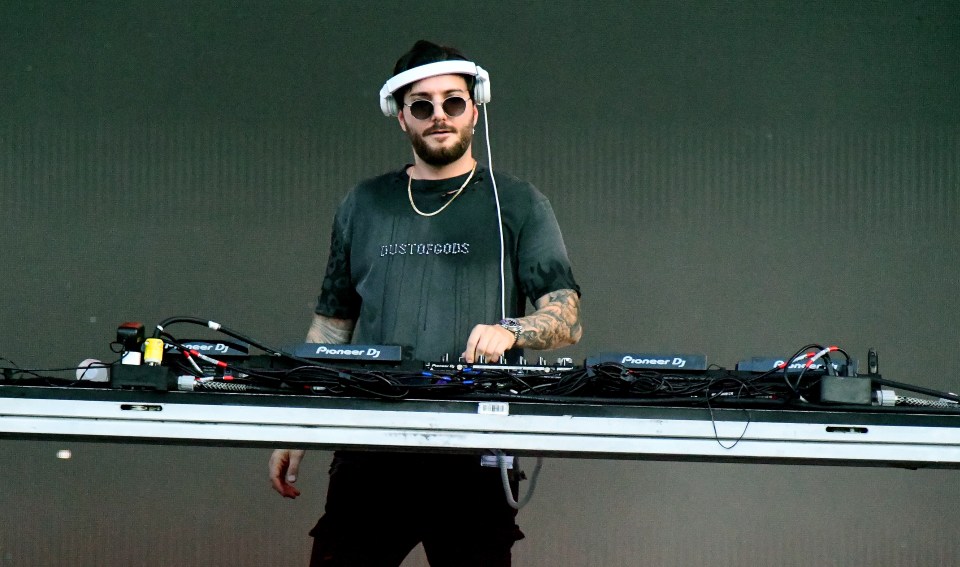 DJ Alesso performing at a concert.