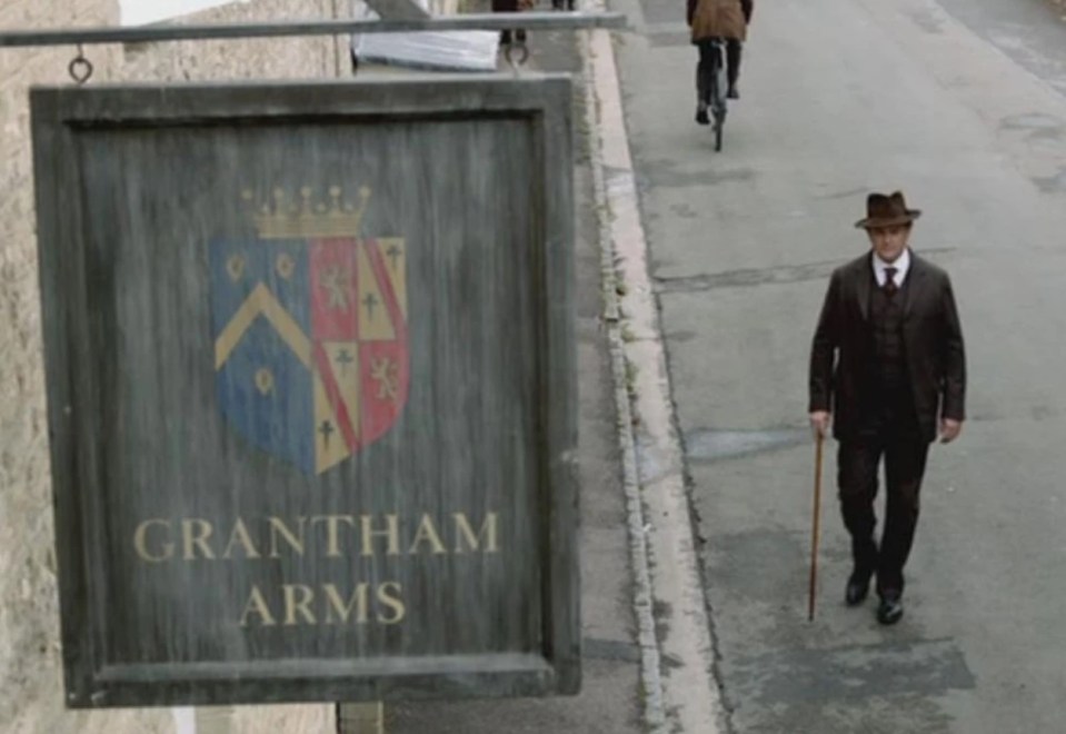 Grantham Arms pub sign and a man walking down the street.