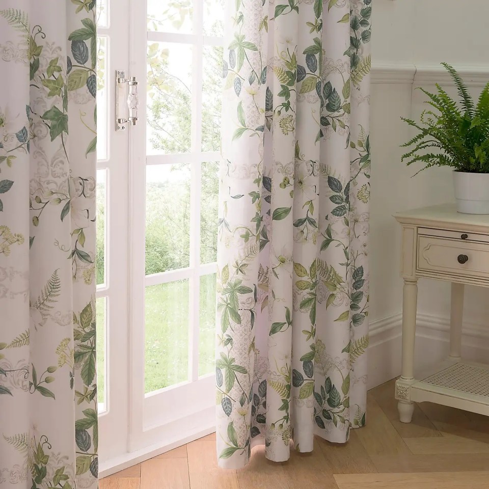 Floral curtains hanging in a room.