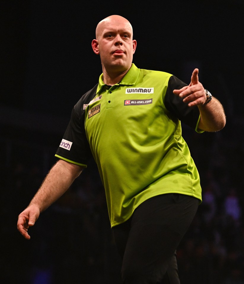 Michael van Gerwen celebrating a 180 during a darts match.