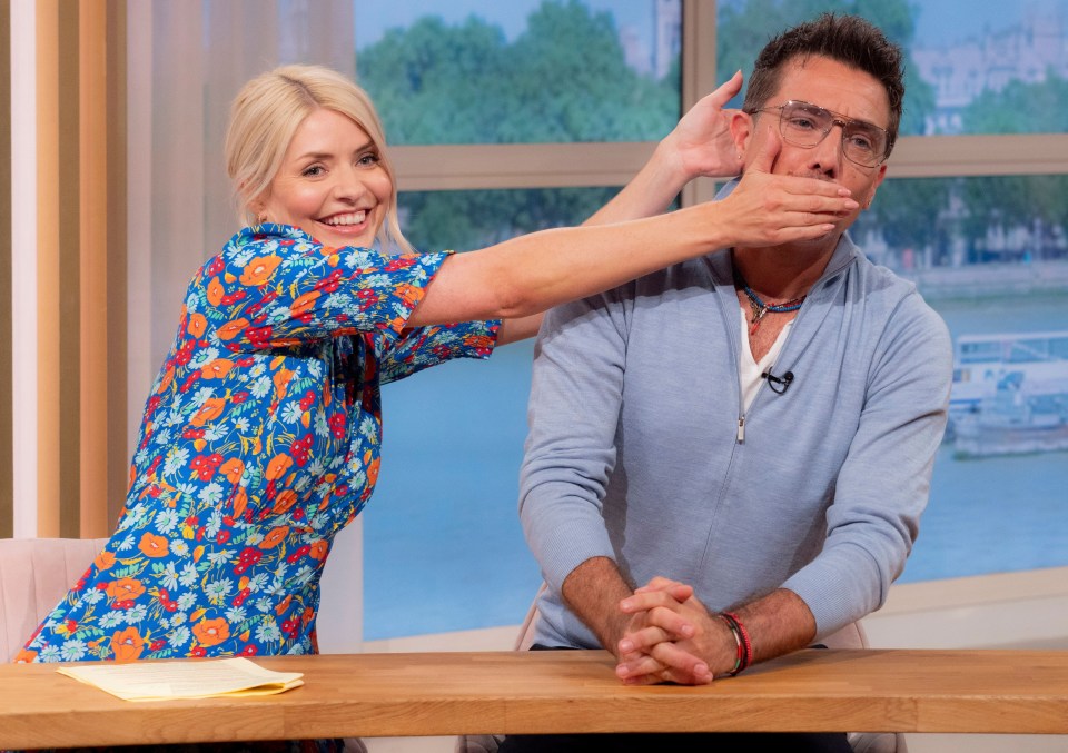 Holly Willoughby playfully covering Gino D'Acampo's mouth on This Morning.