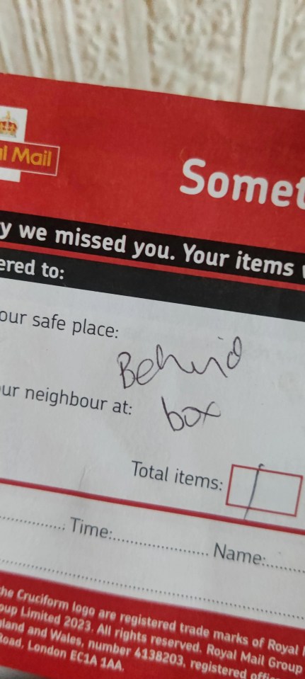 Royal Mail delivery note indicating a package was left behind a box.