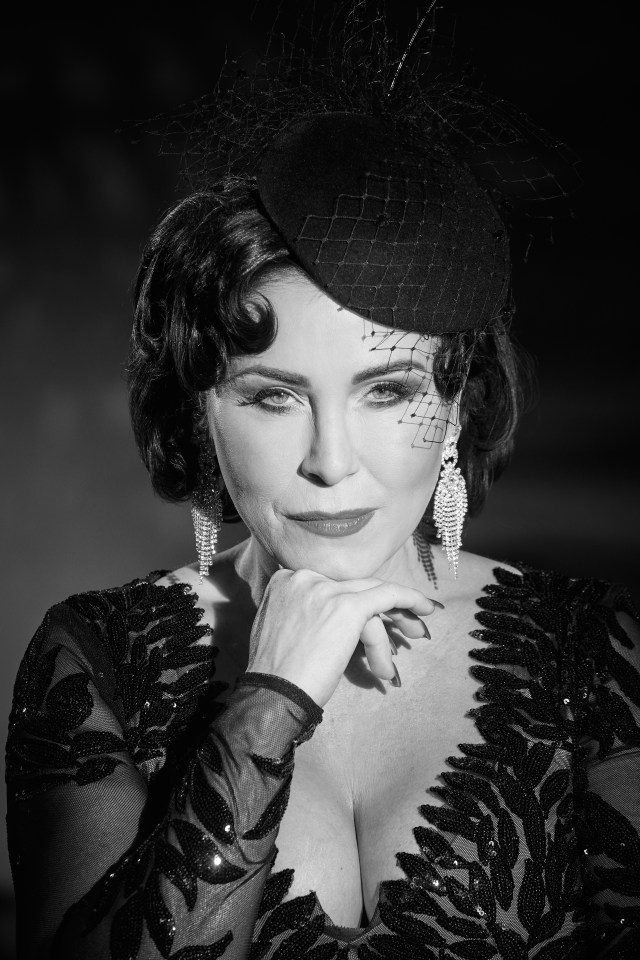 Black and white portrait of a woman in a hat and sequined dress.