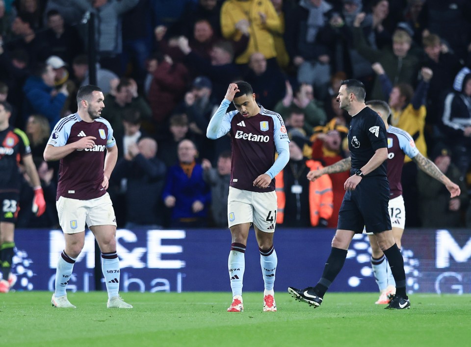 Aston Villa players looking dejected after a soccer game.