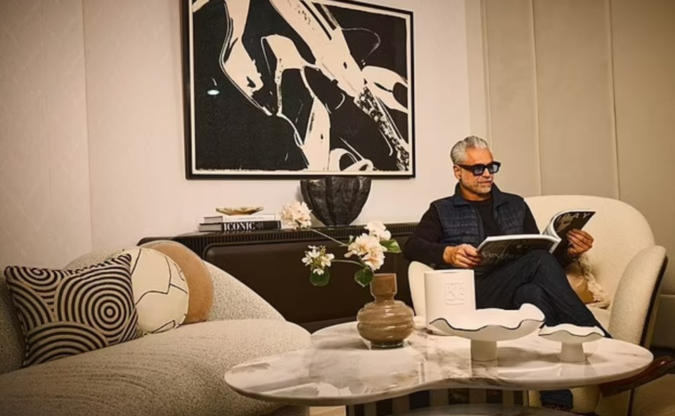 Man reading a magazine in an upgraded lounge area.