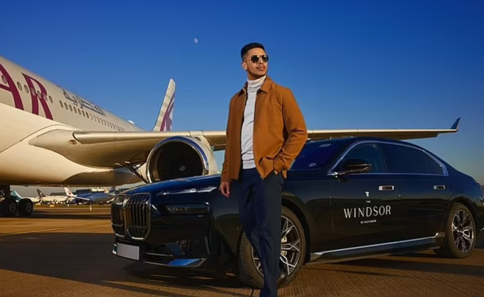 Man standing by a car and airplane.