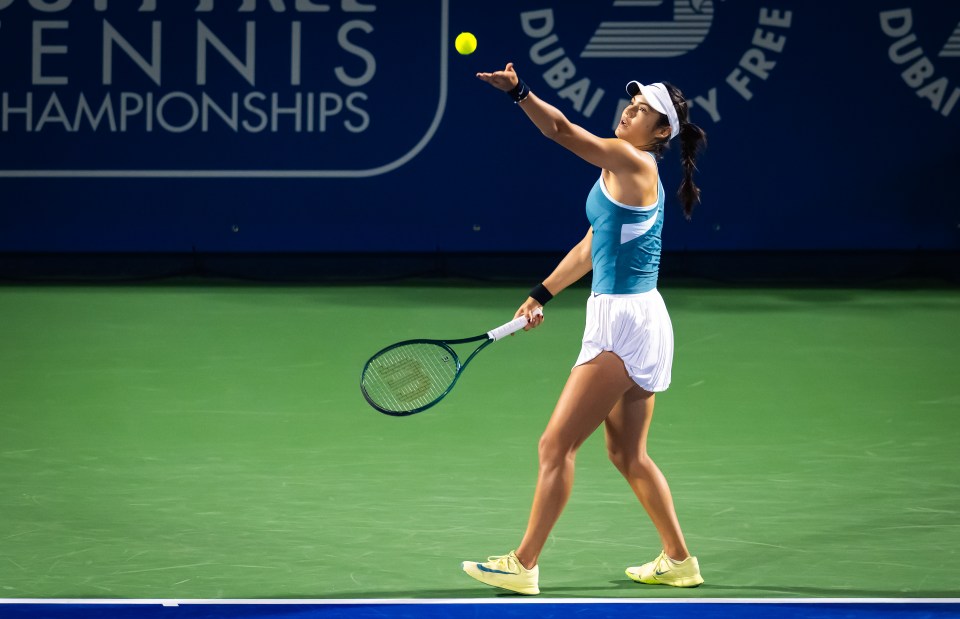 Emma Raducanu serving a tennis ball.