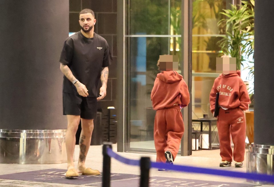 Kyle Walker with his children at a hotel.