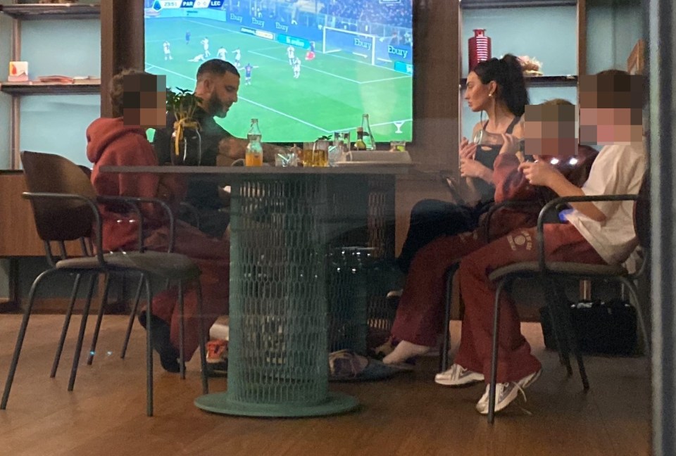 Kyle Walker with his family at a restaurant.