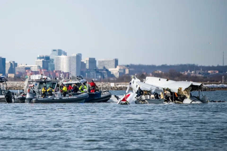 Rescue boats surrounding a plane crash in the water.