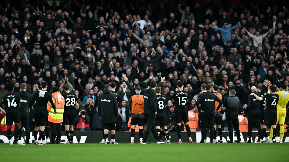 West Ham players celebrating with fans after a Premier League win.