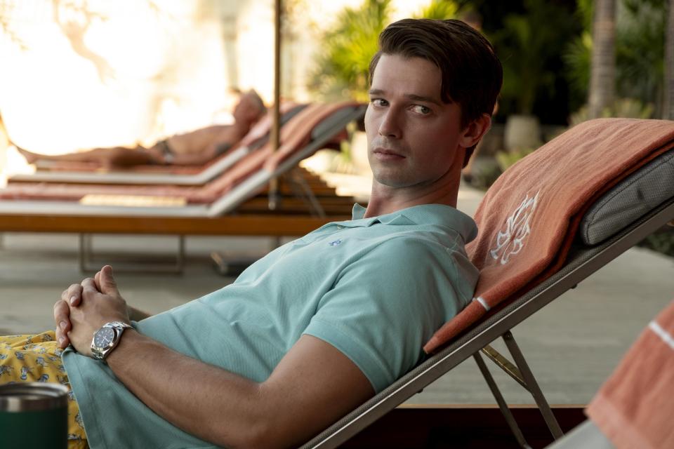 Man relaxing on a lounge chair by a pool.