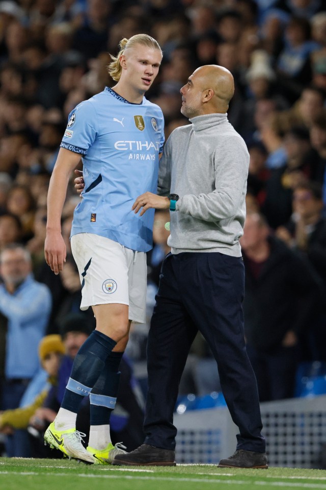 Erling Haaland of Manchester City and manager Pep Guardiola on the field.