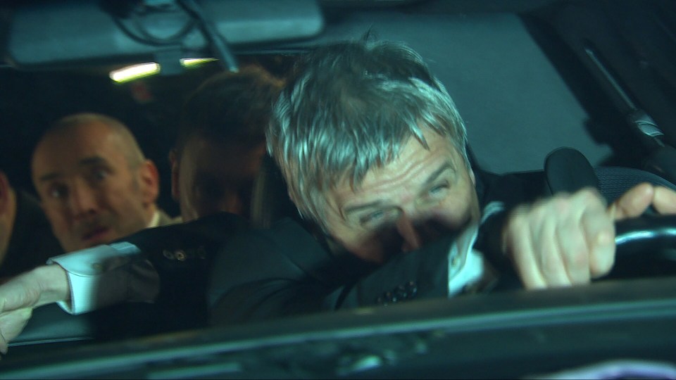 A driver gripping the steering wheel of a car involved in an accident.