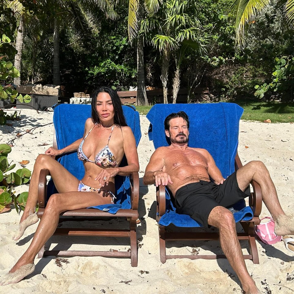 A woman and a man relaxing in beach chairs on a sandy beach.