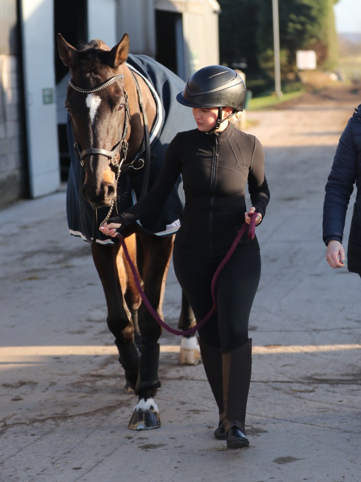 Woman leading a horse.