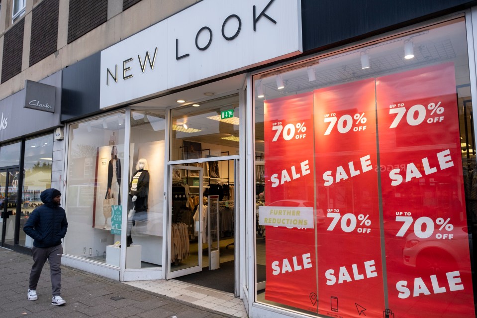 New Look clothing store with 70% off sale signs.