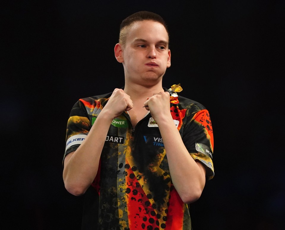 Ricardo Pietreczko celebrates a darts match win.