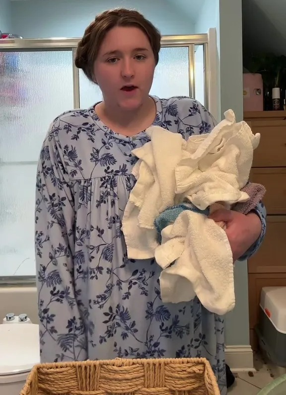 Woman holding a pile of washed reusable toilet paper.