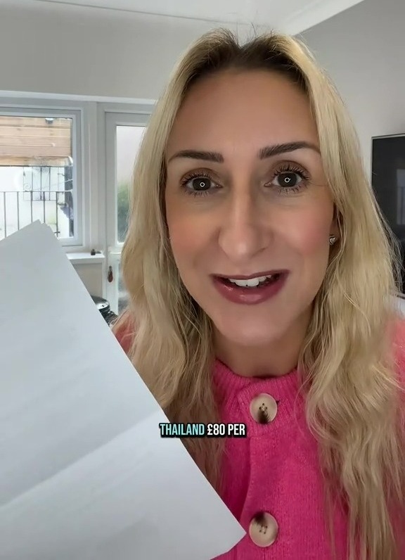 Woman holding a letter showing a £320 fine for taking her children to Thailand during term time.