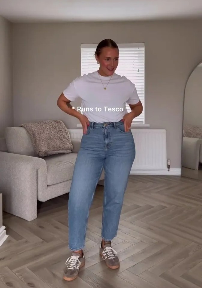 Woman in light wash jeans and white t-shirt.