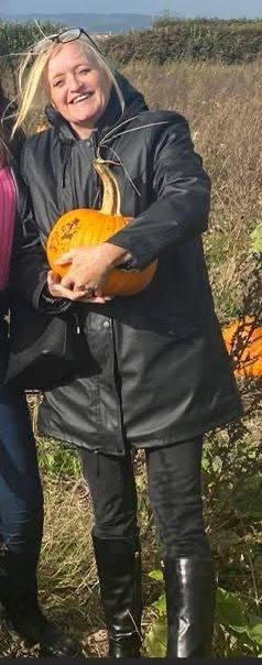 Photo of Sian Jones, a missing 53-year-old woman, holding a pumpkin.