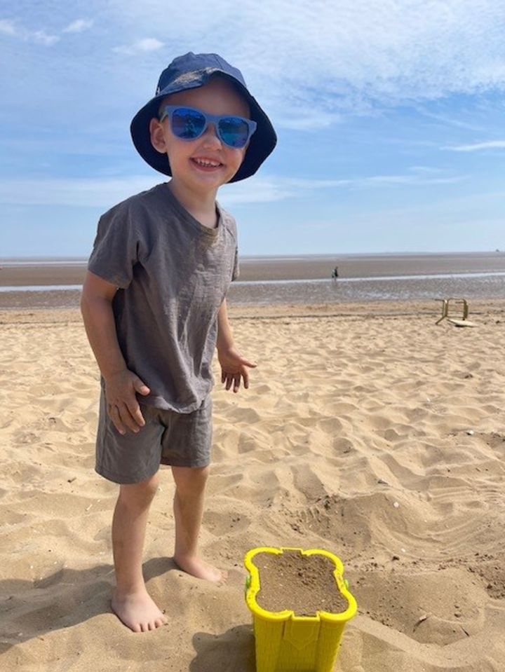 Photo of Albie Speakman, age 3, on a beach.