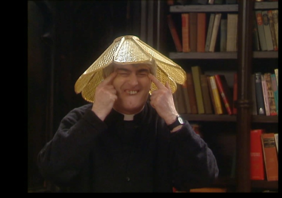 Screen capture of Father Ted wearing a conical hat.