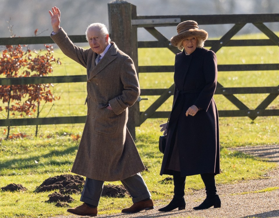 King Charles and Queen Camilla walking and waving after a church service.