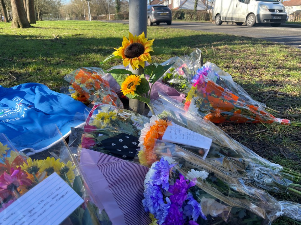 Flowers and a sweatshirt left at a collision scene.