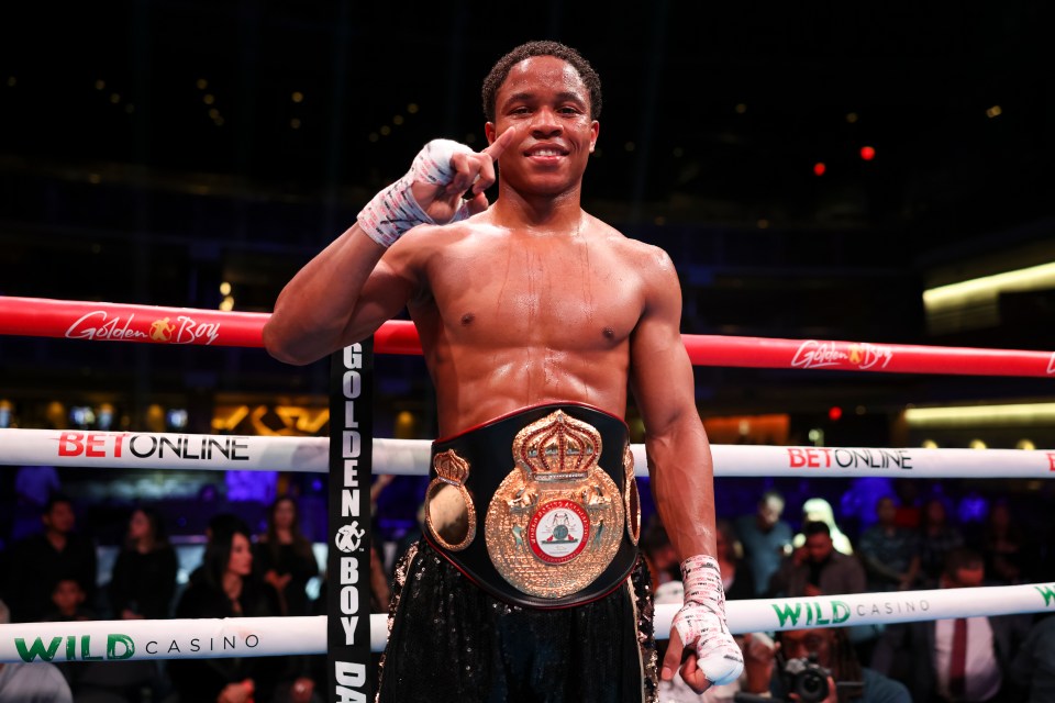 Floyd Schofield victorious in boxing match, holding championship belt.