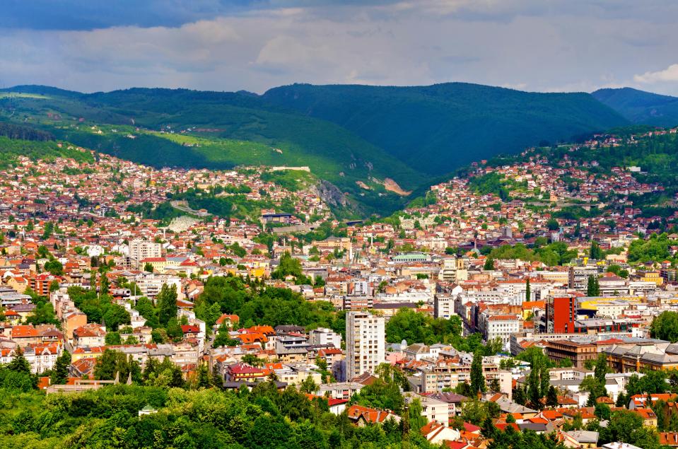 Aerial view of Sarajevo, nestled in mountains.