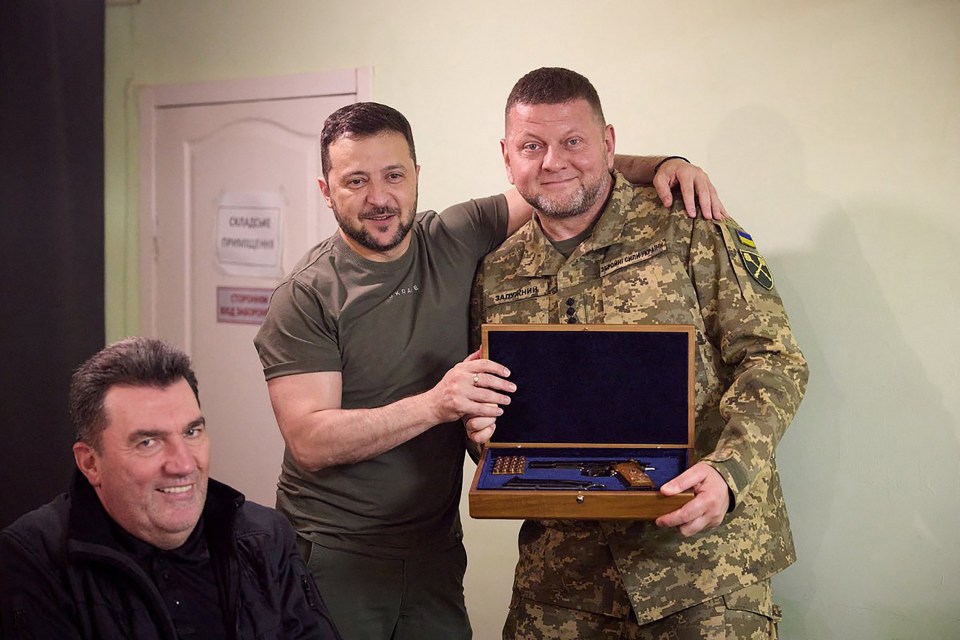 General Valeriy Zaluzhnyi receiving a pistol in a wooden box.