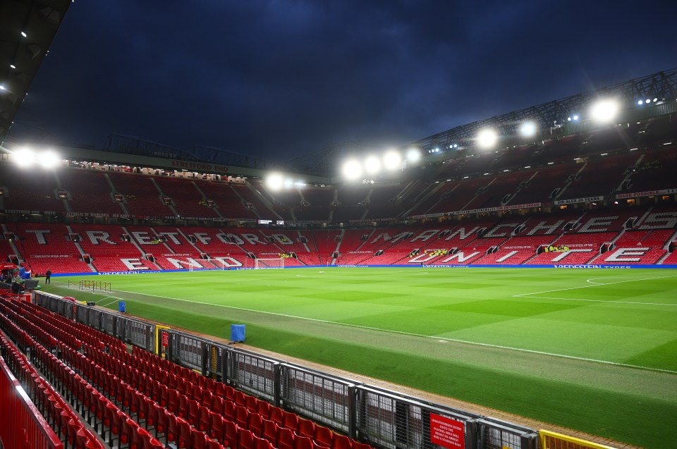 Empty Old Trafford stadium before a soccer match.