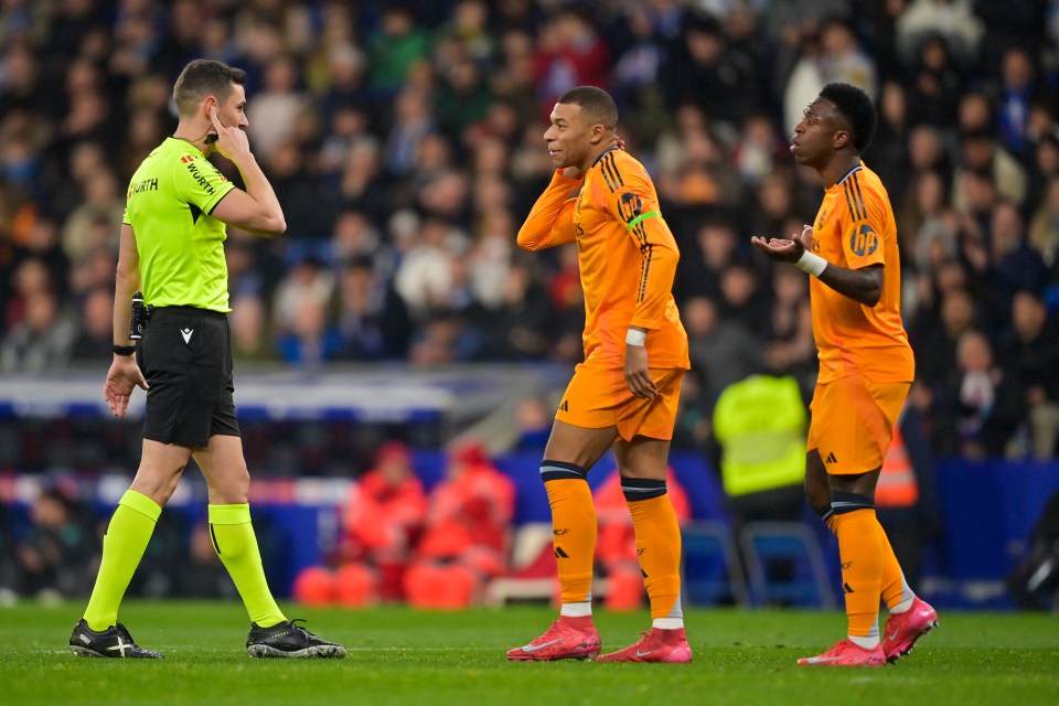 Real Madrid players protesting a disallowed goal to the referee.