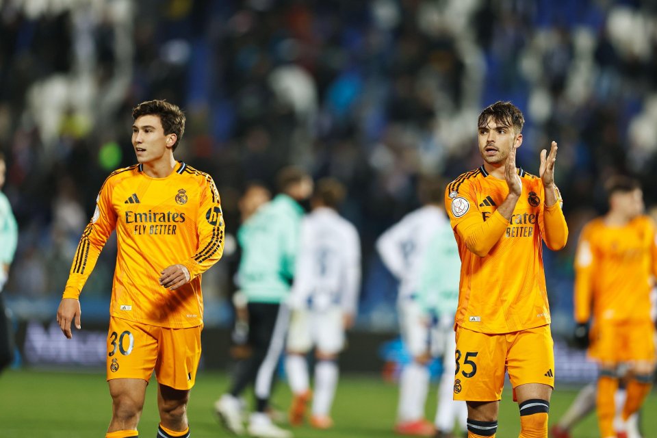 Gonzalo Garcia and Raul Asencio celebrating a Real Madrid victory.