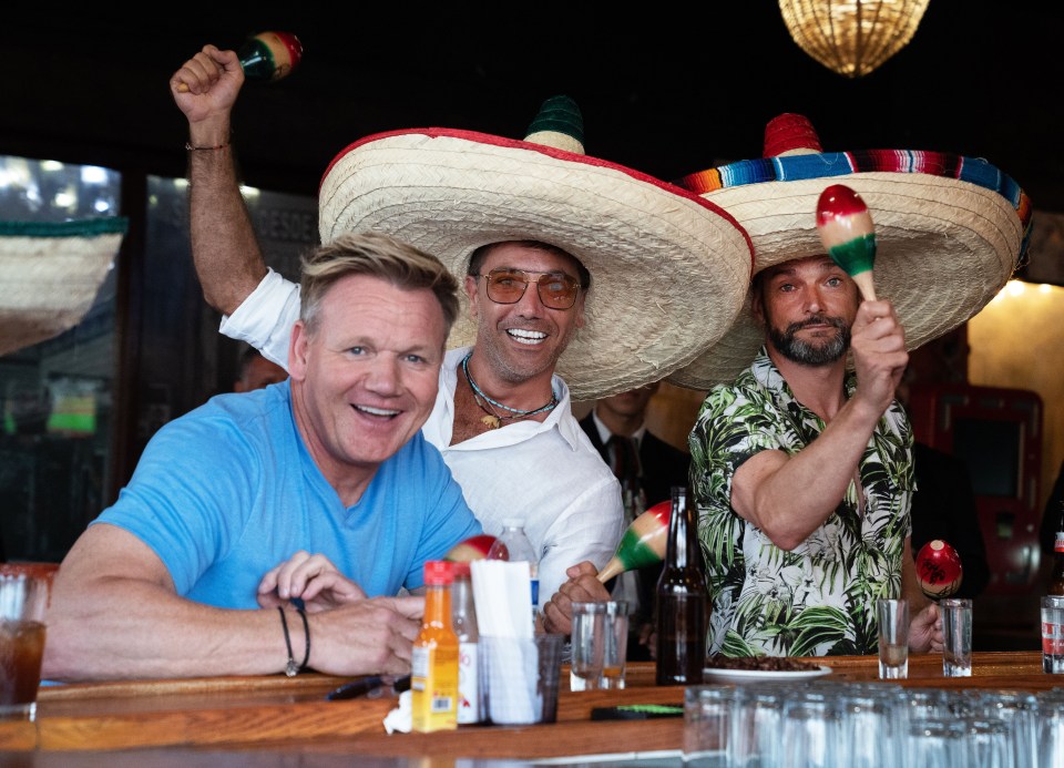 Gordon Ramsay, Gino D'Acampo, and Fred Sirieix in Mexico, wearing sombreros and playing maracas.