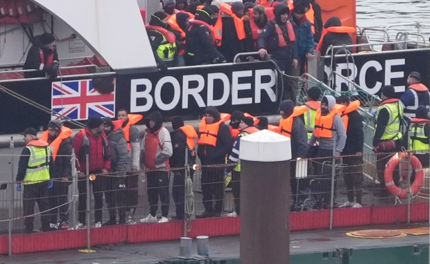 Migrants arriving in Dover, UK, wearing life vests.