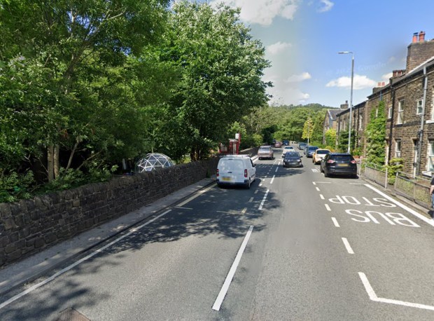 Halifax Road with cars and a bus stop.