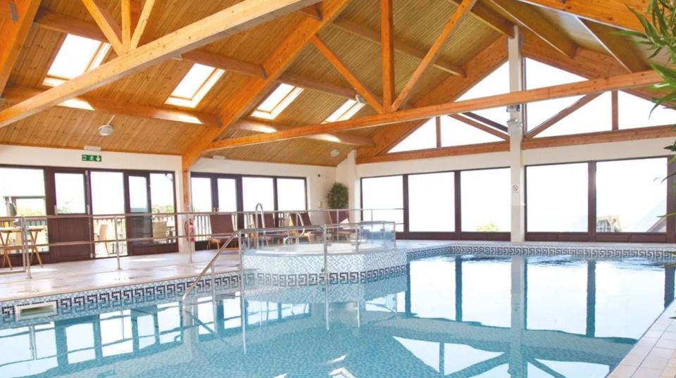 Indoor pool and hot tub at a resort.