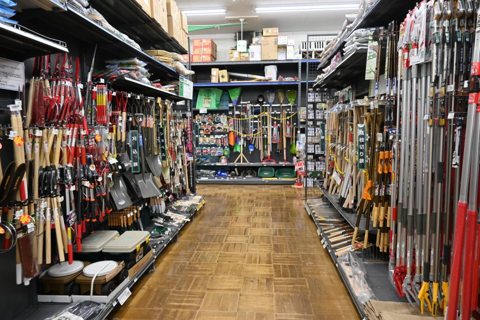 Japanese home improvement store aisle with gardening tools.