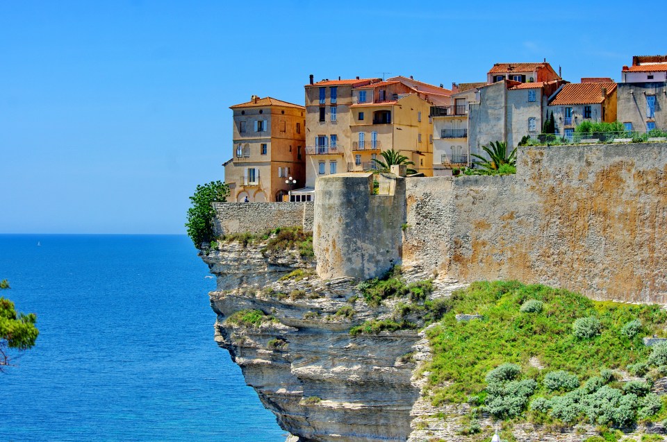 Houses built on a cliff overlooking the sea in Bonifacio, Corsica.