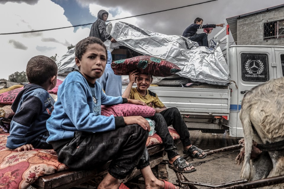 Palestinian children migrating from eastern neighborhoods in Rafah, Gaza.