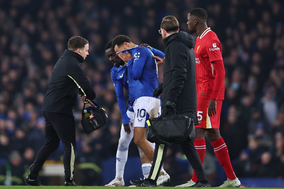 Soccer player Iliman Ndiaye of Everton leaves the field with an injury.