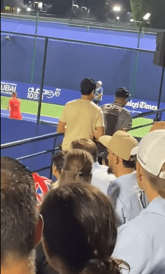 Spectators watching a tennis match.