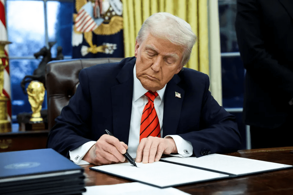 President Trump signing a document.