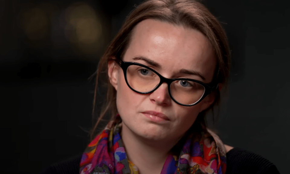 Close-up of a woman wearing glasses and a colorful scarf.