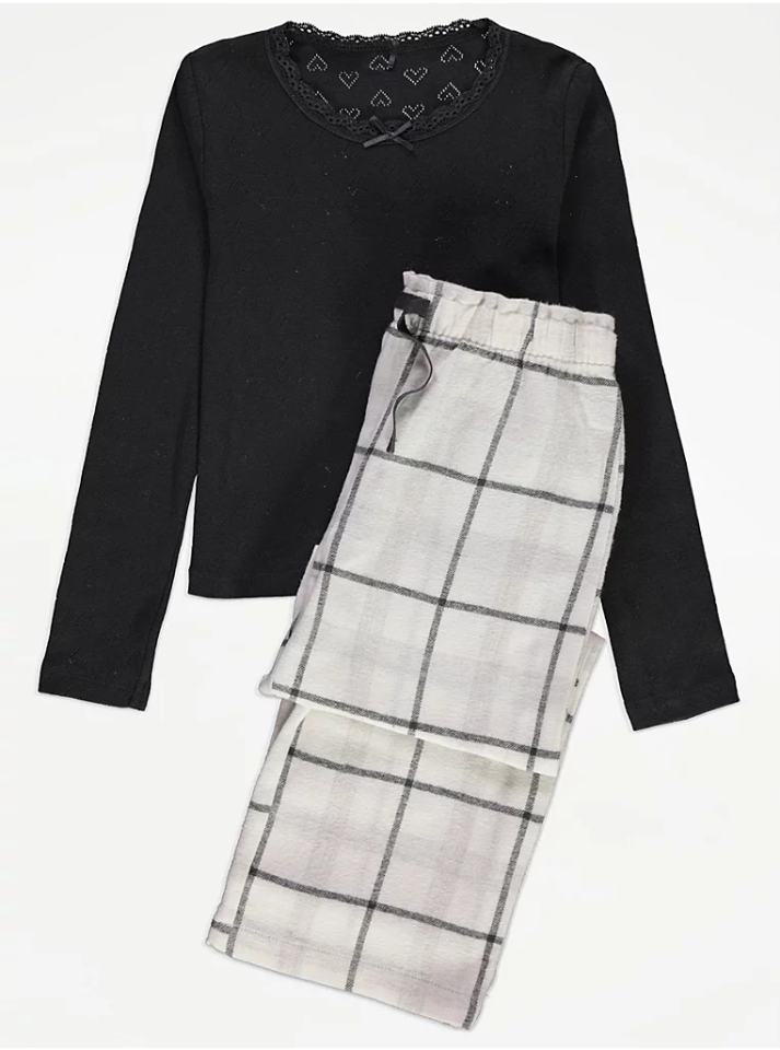 Girls' black long-sleeve shirt and plaid pajama pants.