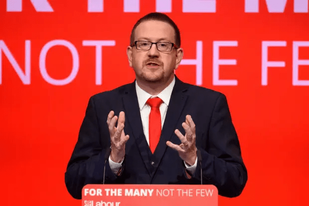 Man in suit giving a speech.